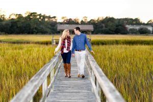 couple-walking-down-marsh-boardwalk-together-at-sunset-couple 3